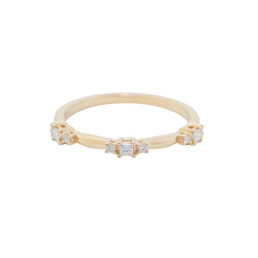 Introducing the 14K Yellow 1/6 CTW Natural Diamond Stackable Ring: a delicate gold band featuring five elegantly spaced, square-cut diamonds. This minimalistic and sophisticated design embodies timeless elegance.