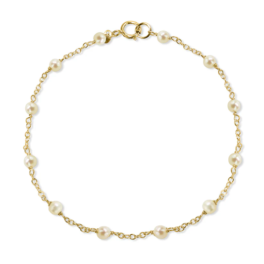 The 14k White Pearl Station Bracelet from the Goddess Jewelry Collection is a delicate gold chain bracelet featuring evenly spaced white pearls connected by thin gold links, with a small gold clasp. Its elegant and simple design is ideal for those seeking refined jewelry.