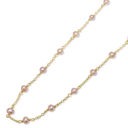 The 14k Natural Pink Pearl Station Necklace from Goddess Jewelry is a delicate gold chain with evenly spaced pinkish pearls.