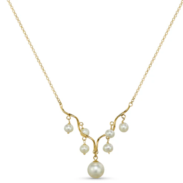 The 14k White Pearl Wave Bar Necklace from the Goddess Jewelry Collection is a gold piece featuring a delicate chain and an asymmetrical pendant with seven white pearls on flowing gold strands, exuding elegant, divine charm.