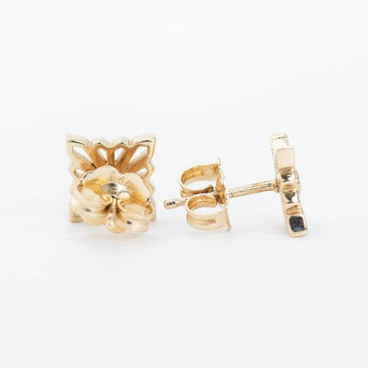 A pair of Stuller 14k Yellow Gold Star Geometric Earrings is elegantly displayed on a light background, with one earring shown from the front and the other from the side, highlighting the intricate butterfly backing mechanism.
