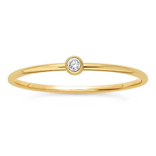 A delicate 14K gold ring by Rio Grande features a solitary lab-grown diamond in a minimal bezel setting, shown on a white background.