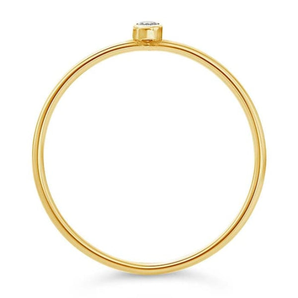 The Rio Grande 14K Dainty Lab-Grown Diamond Ring is a minimalist and elegant piece featuring a small diamond set vertically in yellow gold. Ideal for stacking, it boasts timeless grace against its white backdrop.