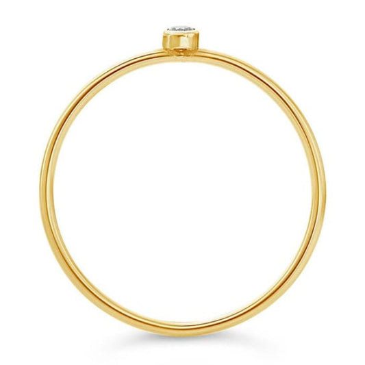 The Rio Grande 14K Dainty Lab-Grown Diamond Ring is a minimalist and elegant piece featuring a small diamond set vertically in yellow gold. Ideal for stacking, it boasts timeless grace against its white backdrop.