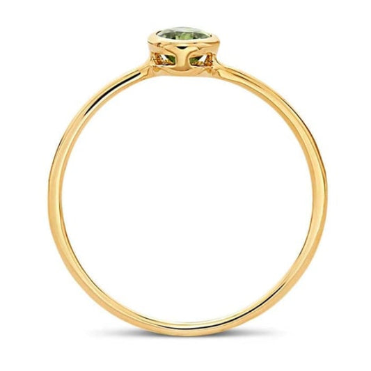 The Rio Grande 14K Yellow Gold Oval Peridot Ring (Size 7) features a delicate four-prong setting and a AAA-Grade Peridot, showcasing its minimalistic elegance with a thin, polished band.