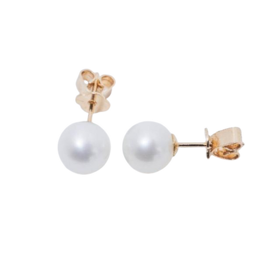 Placed side by side on a white background, these Jewelmak earrings are 14k white freshwater pearl 7mm studs featuring smooth, round pearls with gold posts and butterfly backs, reflecting light gently.