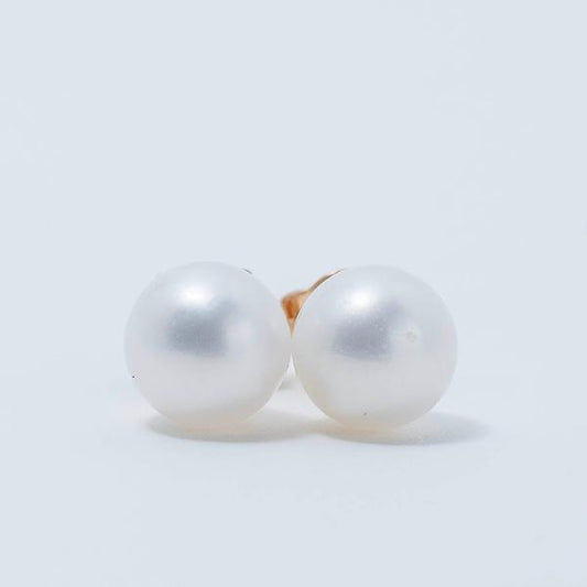 The Jewelmak Youth 14K Freshwater Pearl 5mm Stud Earrings, featuring AAA+ quality pearls with a soft luster, are set in 14k yellow gold and displayed against a plain white backdrop.