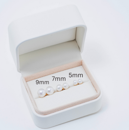 A white jewelry box contains three pairs of exquisite pearl earrings, each featuring freshwater pearls arranged in 9mm, 7mm, and 5mm sizes from largest to smallest. Set in luxurious yellow solid gold to accentuate their graceful size variation.