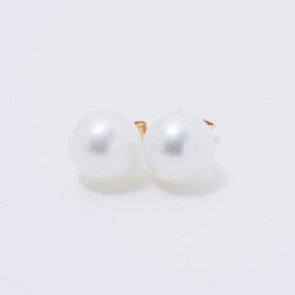 A pair of 14k white freshwater pearl stud earrings, featuring 9mm pearls, displayed on a plain light background.