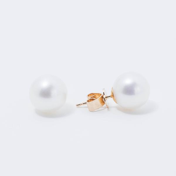 A pair of classic 14k white gold stud earrings, adorned with lustrous 9mm freshwater pearls, set elegantly against a plain white background.